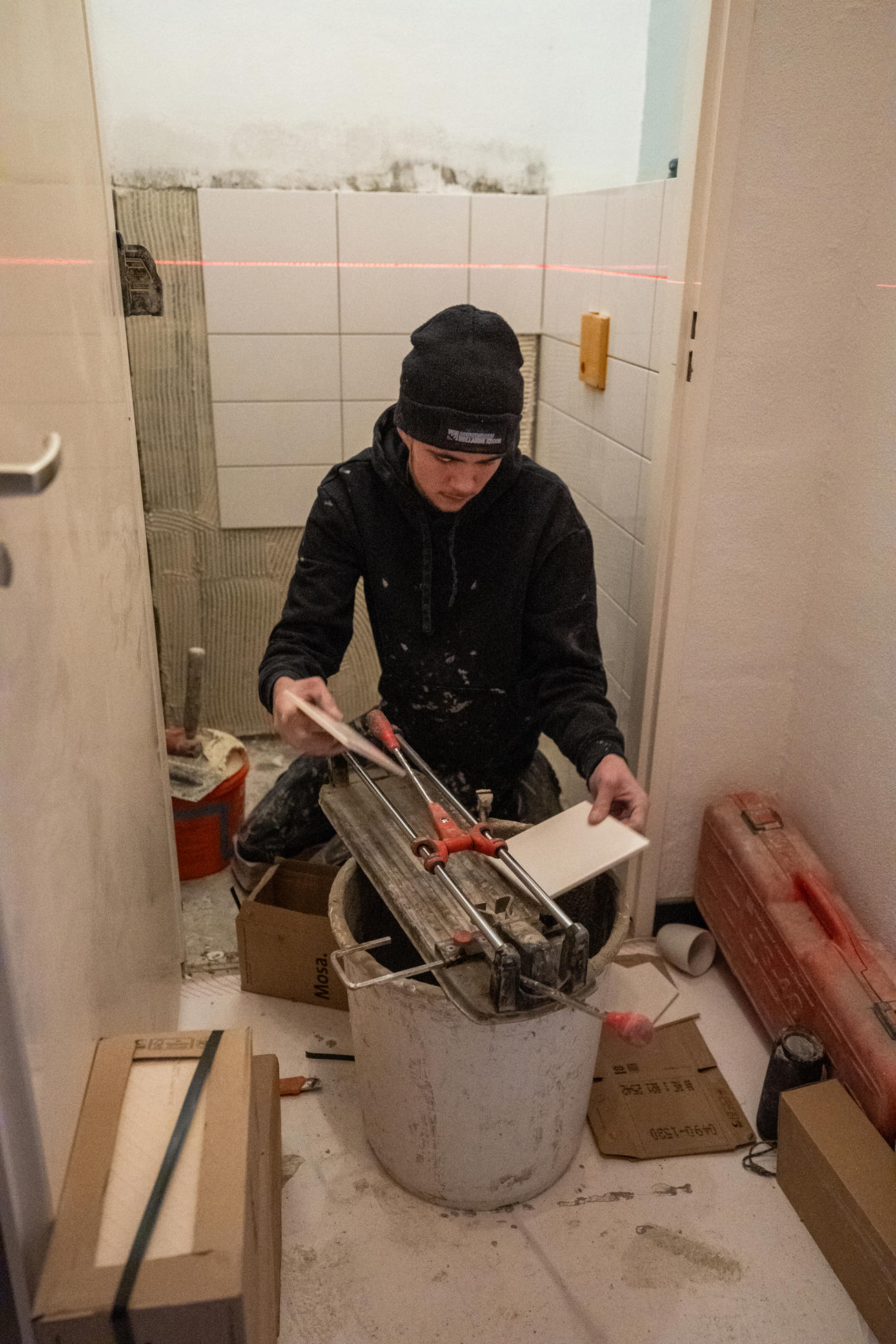 Werknemer die bezig is met de renovatie in het toilet
